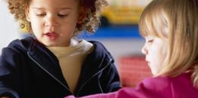Brand X Pictures/Brand X Pictures/Getty Images Social interaction and sharing will help preschoolers learn to deal with jealousy.