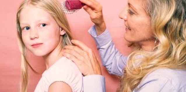Brand X Pictures/Brand X Pictures/Getty Images Teach your child about hair brushing.