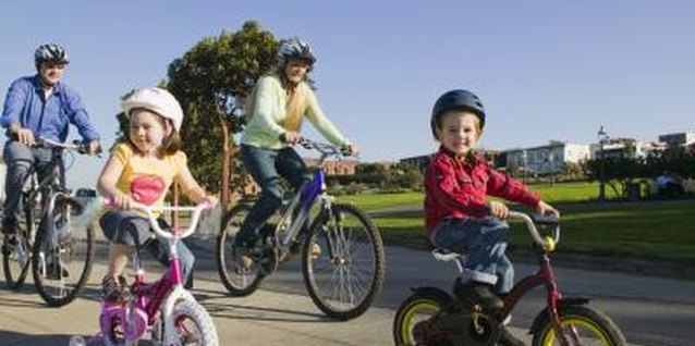 Jupiterimages/Comstock/Getty Images A family bike hike lets you model and teach bicycle safety for your kids.