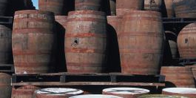 Jupiterimages/Photos.com/Getty Images Old whiskey barrels are often cut in half for use in the garden.