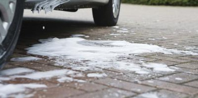 Jupiterimages/BananaStock/Getty Images You can eliminate driveway grass and replace it with pavers or gravel.