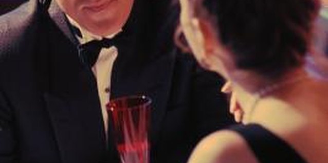 Stockbyte/Stockbyte/Getty Images Secluded candlelight dinners may be romantic or covering up his hidden relationship.