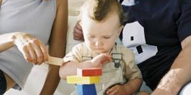 BananaStock/BananaStock/Getty Images Building blocks enable your 2-year-old to sort and stack, promoting both fine- and gross-motor skills.