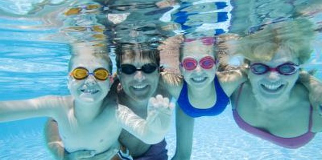 Polka Dot Images/Polka Dot/Getty Images Goggles prevent eye irritation and make it easier to see in the water.