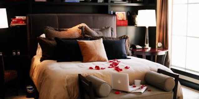 Jupiterimages/Photos.com/Getty Images Moody colors transform your bedroom into a seductive retreat.