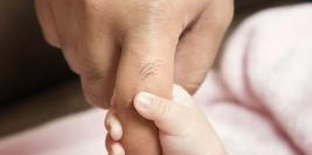 Jupiterimages/Comstock/Getty Images Grasping activities help kids develop fine motor skills.
