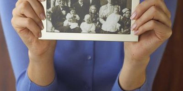 Brand X Pictures/Brand X Pictures/Getty Images Family pictures may provide clues to your father's relatives.