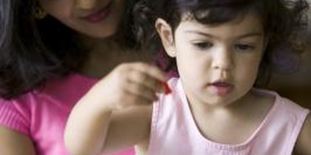 Photodisc/Photodisc/Getty Images Distract your toddler from face picking by playing games together.