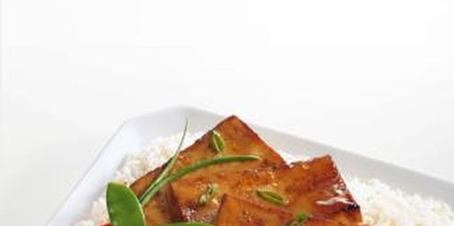 Jupiterimages/Comstock/Getty Images Eat tofu instead of meat and you can fill up on fewer calories.