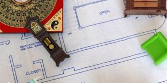Creatas/Creatas/Getty Images Feng shui compass with doll furniture and tea.