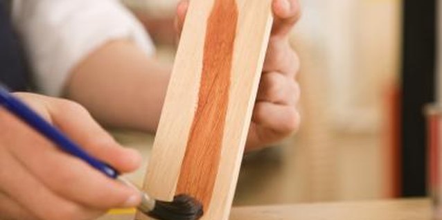 Jupiterimages/BananaStock/Getty Images You can use regular wood stain to color rub furniture.