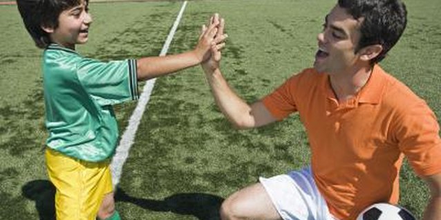Jupiterimages/Brand X Pictures/Getty Images Many young children enjoy giving a high-five to recognize accomplishments.