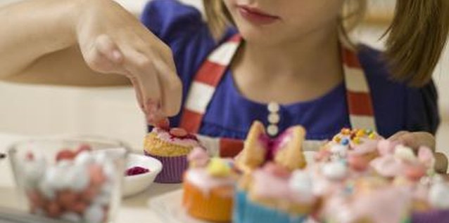 Jupiterimages/BananaStock/Getty Images Send the kids home with treats they'll remember by letting each child make a personalized cupcake.
