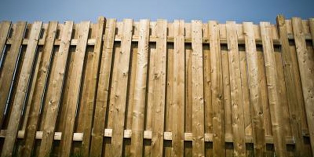 Jupiterimages/Photos.com/Getty Images A backyard fence is a decorating opportunity in waiting.