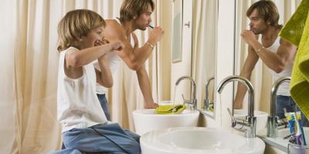 Jupiterimages/Polka Dot/Getty Images Demonstrating how to spit can be a good way to teach your child to do the same.