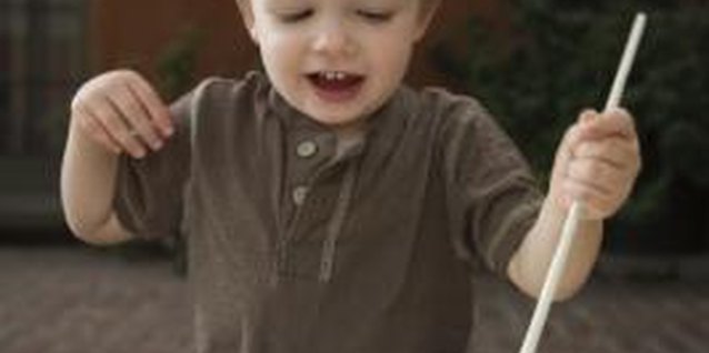 Jupiterimages/Comstock/Getty Images Young toddlers aren't always interested in using artistic tools correctly.