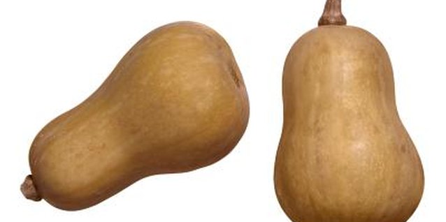 Brand X Pictures/Brand X Pictures/Getty Images Butternut squash is a yellowish-tan color at full maturity.