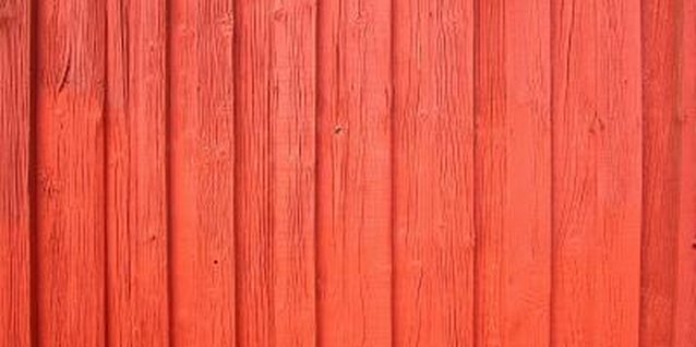 NA/Photos.com/Getty Images Board-to-board fences can be dressed up with color or other stylized design features.