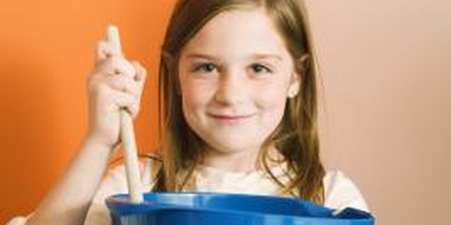 Jupiterimages/Brand X Pictures/Getty Images Teaching your young child to cook can be a simple -- albeit messy -- process.