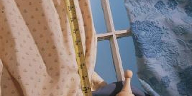 Comstock/Stockbyte/Getty Images Drape the reshaped panels from new hardware to update the look.