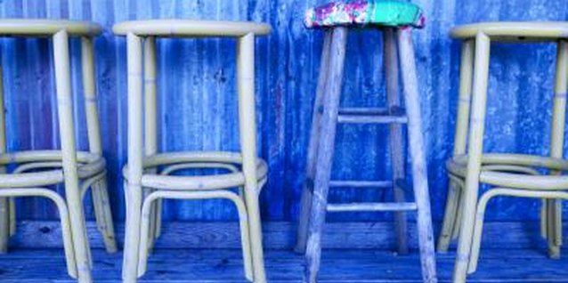 Jupiterimages/Photos.com/Getty Images Make old, wooden bar stools cozy and colorful.