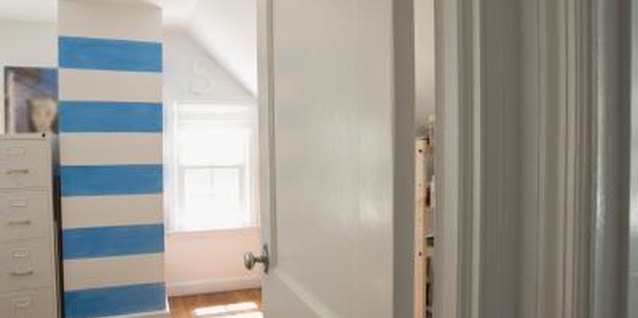 Jupiterimages/Comstock/Getty Images Horizontal blue stripes brings a bland wall to life. Add thin yellow lines for a nautical look.