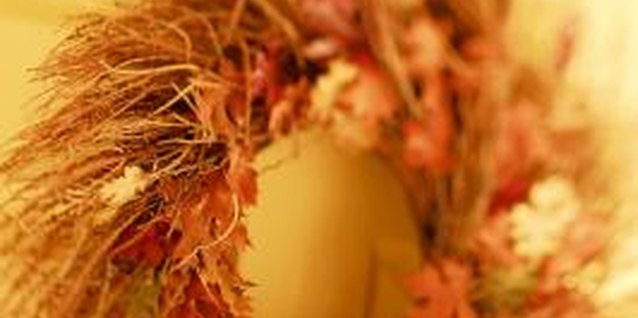 Comstock/Comstock/Getty Images Hanging seasonal decorations with nails can mar doors.