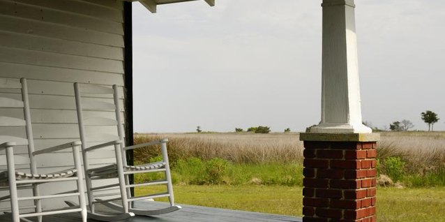 EJ-J/iStock/Getty Images Finishing techniques give a bright white chair a rustic appearance.