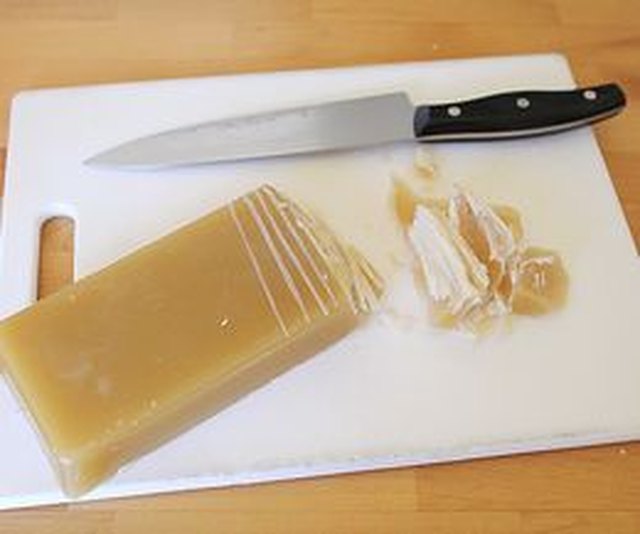 Score the beeswax before cutting it into smaller pieces.