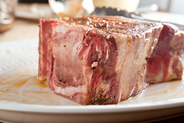 Thick raw T-Bone on a plate.