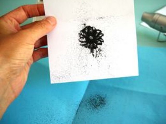 Tap off excess powder.