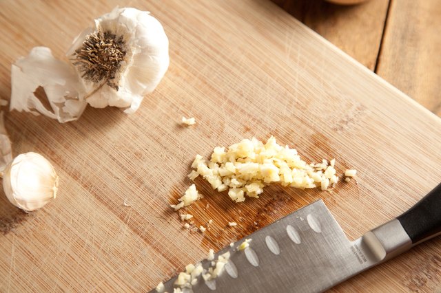 Minced garlic on cutting board.