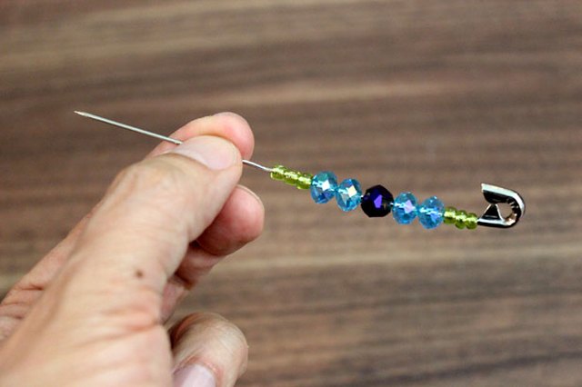 String the beads with the safety pin wire