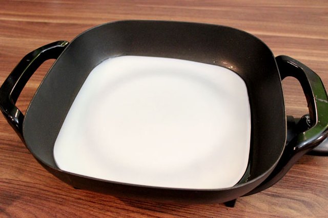 Melt beeswax in an electric skillet