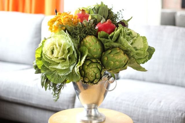 Seasonal fruits and vegetables serve as elegant and edible floral arrangements.