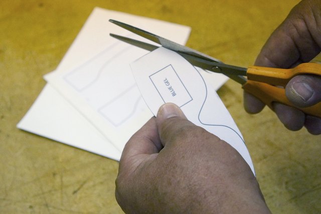 Cut parts from paperboard.