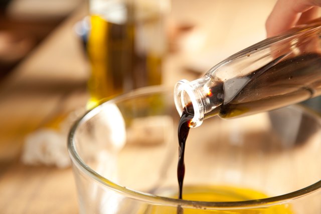 Worcestershire sauce poured into mixing bowl with olive oil.