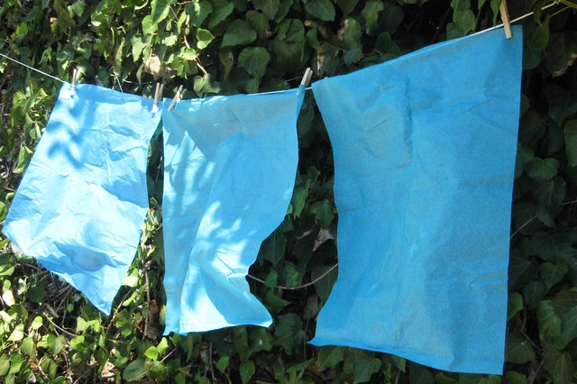 Spray tissue paper with fire-retardant spray.