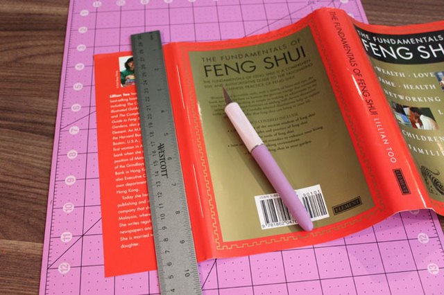 Cut two slits in dust cover