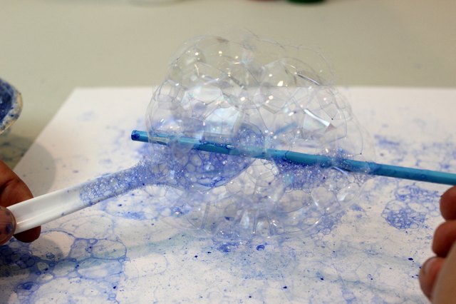 Scoop the bubbles onto paper