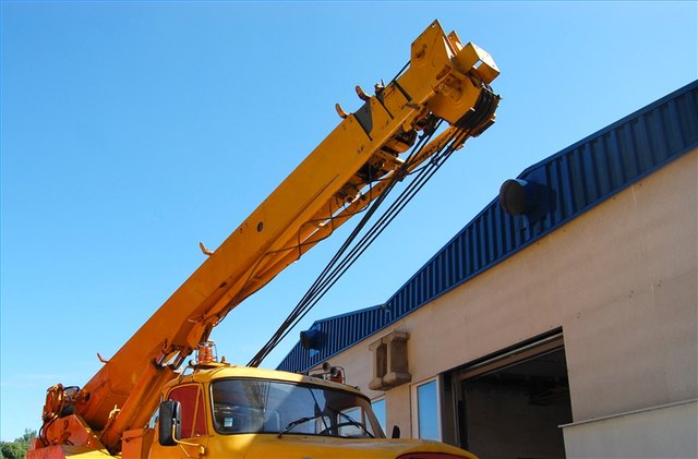 A crane operator inspects and maintains his crane against any defect or malfunctions.