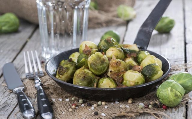 Roasted brussels sprouts on small pan.