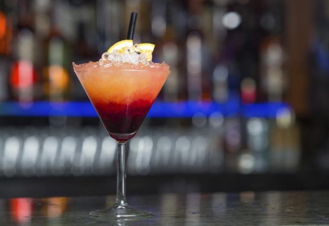 A specialty cocktail on a bar.