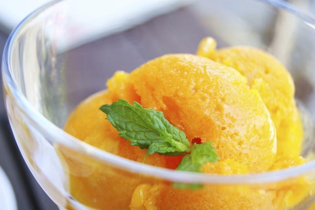 Small bowl of orange sherbet.