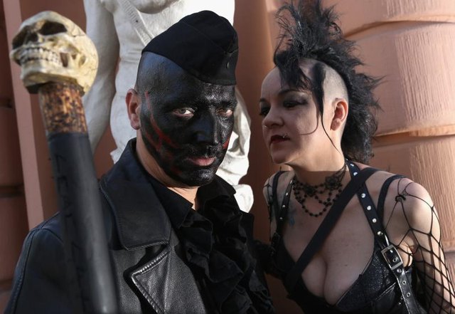 A Goth couple pose for a photograph
