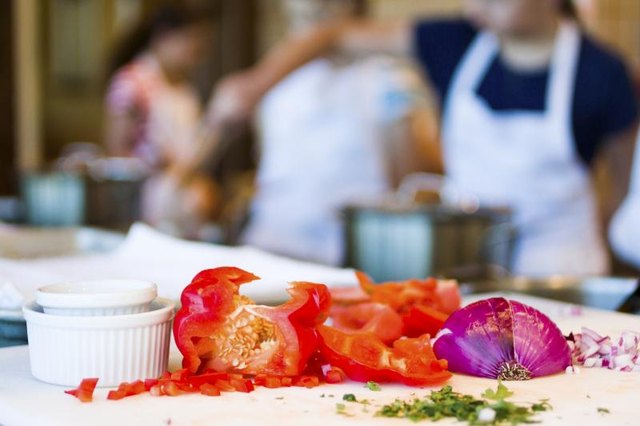 Students at a prep counter during a cooking class.