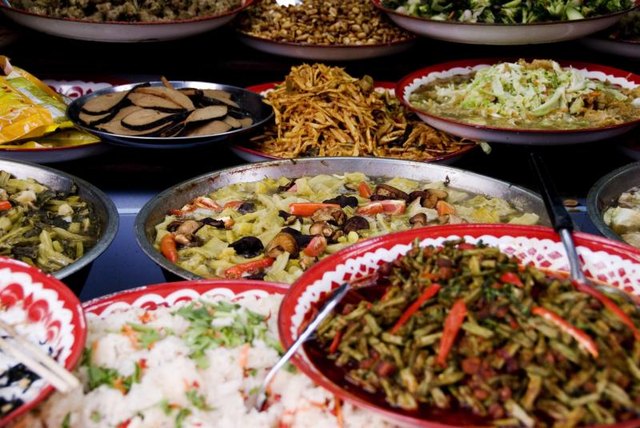 Plates of ethnic dishes on a table.