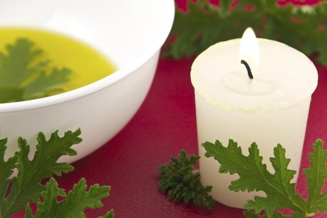 Citronella oil with candle and leaves.