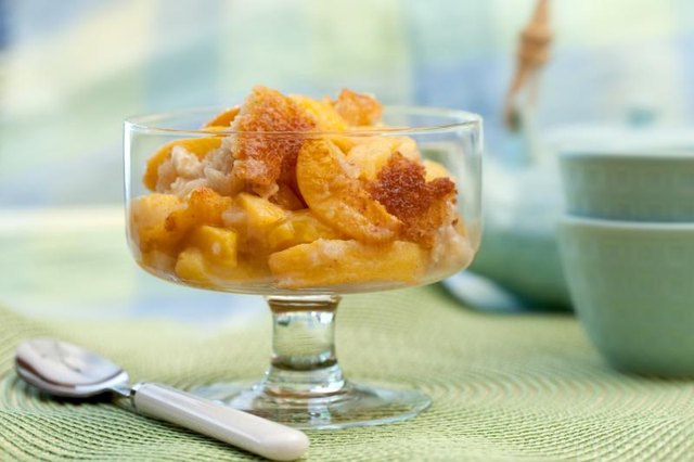 Peach cobbler in a dessert glass.