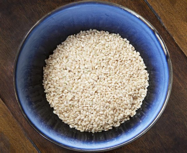 A blue bowl filled with brown rice.